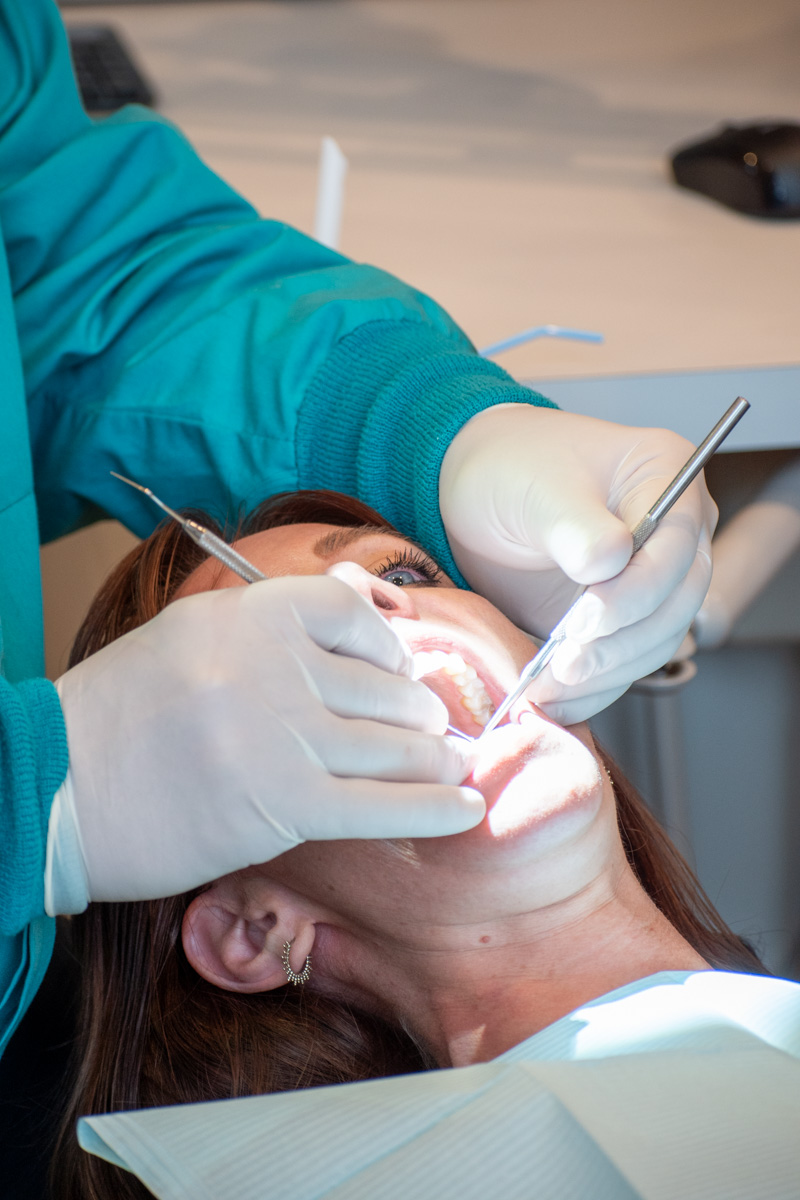 Dentist performing routine oral checkup